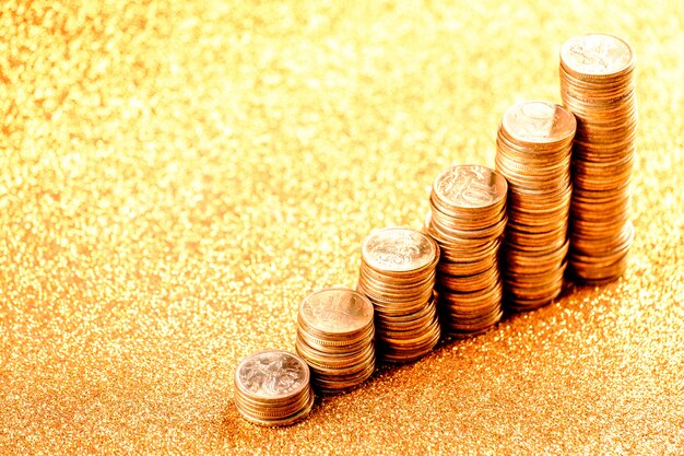 Stacks of copper coins on golden background