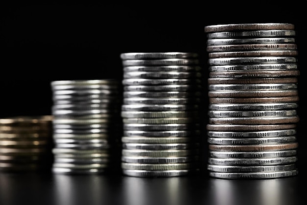 Stacks of metallic coins on a dark background