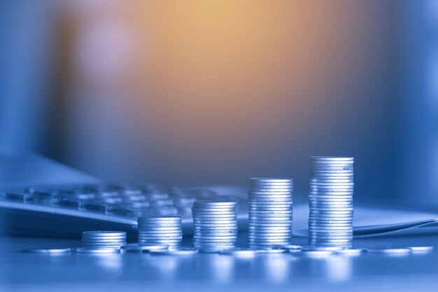 stacks of money coin background concept saving money with blue filter