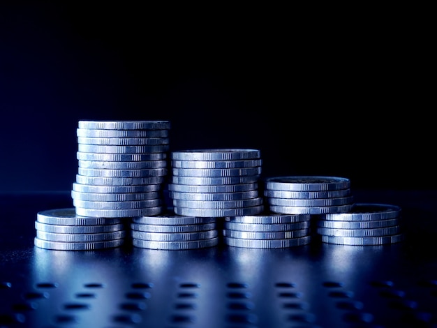 stacks of money coin on black background with copy space Saving money concept