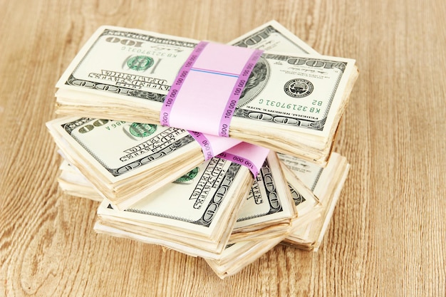 Photo stacks of money on wooden table