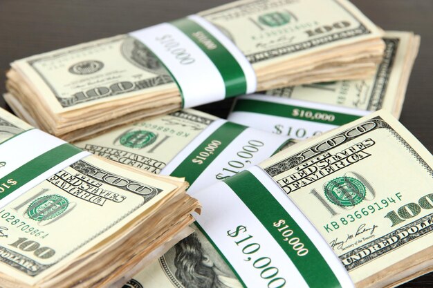 Photo stacks of money on wooden table