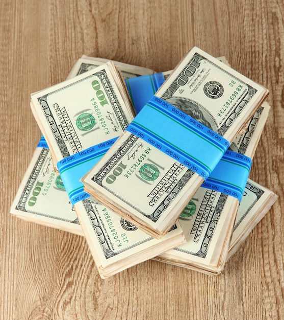 Photo stacks of money on wooden table