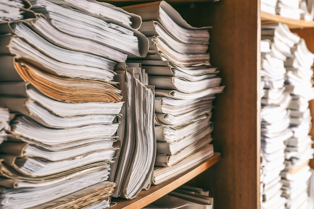 Stacks of old folders with documents in archive