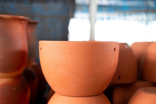 Stacks of orange various terracotta pots for plants for sale at a garden store