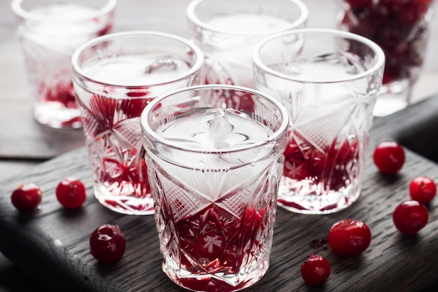 Stacks of vodka and cranberries on a wooden stand