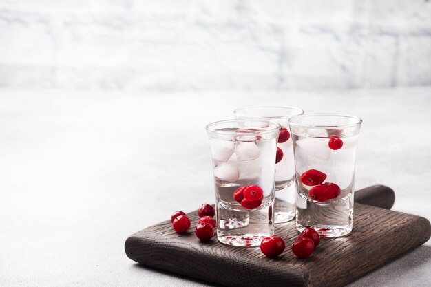 Stacks of vodka and cranberries on a wooden stand