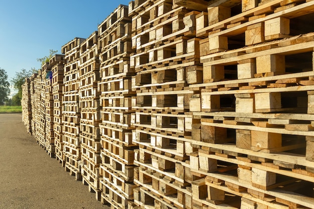 Stacks of wooden pallets in a warehouse yard of factory