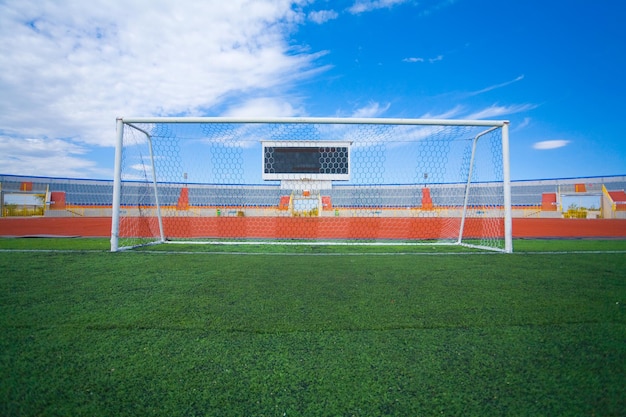 STADIUM Football field with goal and tablo on blue sky