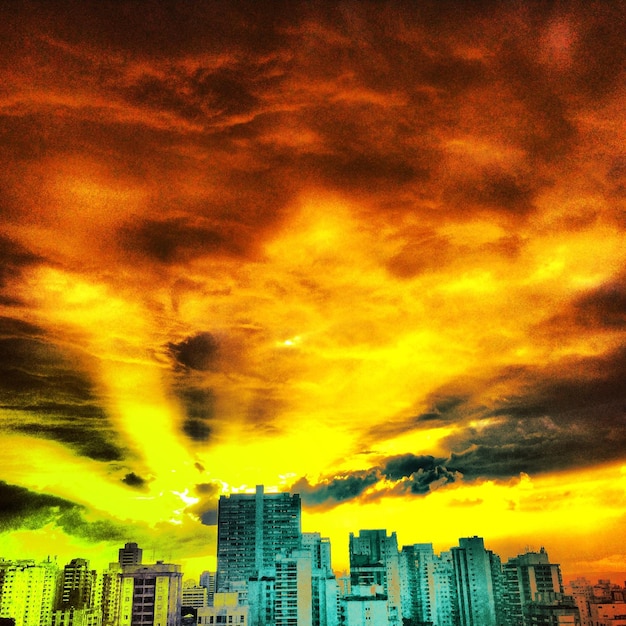 Stadsbeeld tegen een bewolkte hemel bij zonsondergang