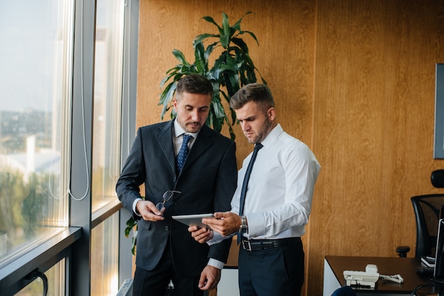 The staff in the office to discuss business matters next to the window. Business, Finance