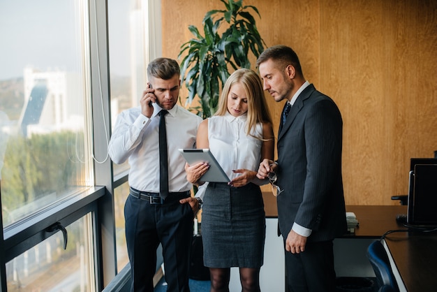 The staff in the office to discuss business matters next to the window. Business, Finance