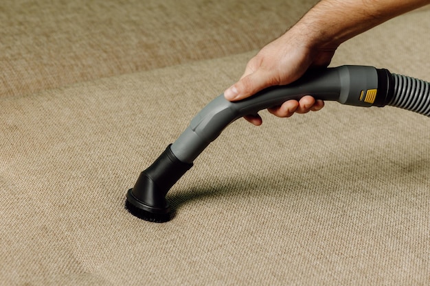Staff produces upholstered furniture cleaning vacuum cleaner on floor