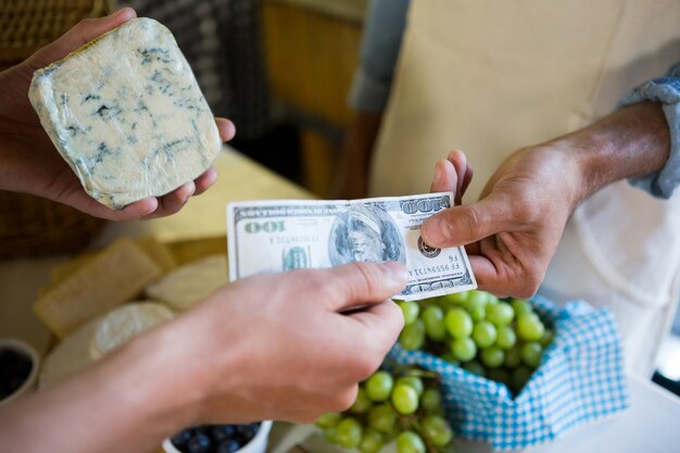 Staff receiving payment from the customer in market