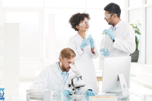 Staff of the scientific medical laboratory congratulating each\
other on their success