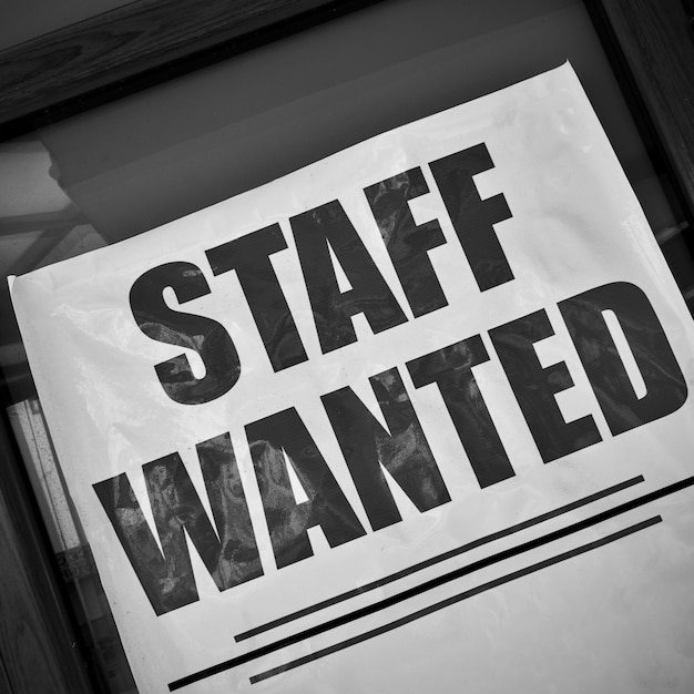 Staff wanted - job vacancy poster in a show-case. Black and white