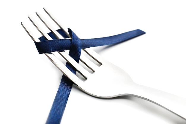 Photo stages of tying bow on fork closeup