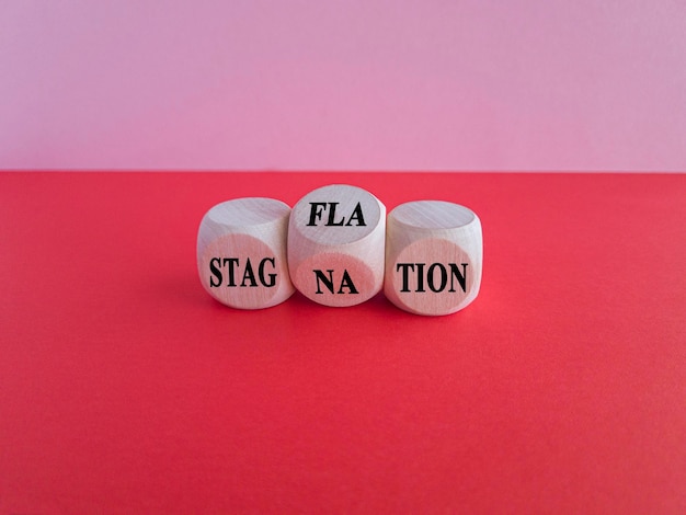 Stagflation or stagnation symbol Turned cubes changes the word stagnation to stagflation