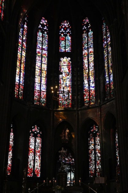 A stained glass window in a church with the word saint - gaudens on the bottom right.