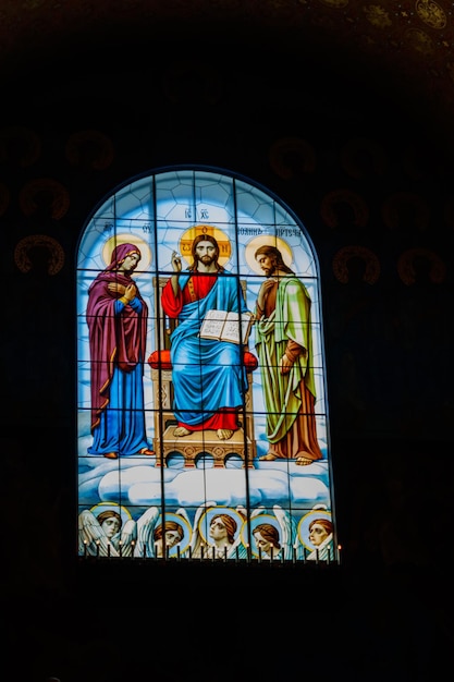 Stained glass window depicting Jesus Virgin Mary and St John the Baptist