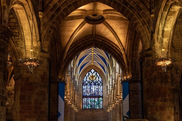 A stained glass window is in a cathedral.