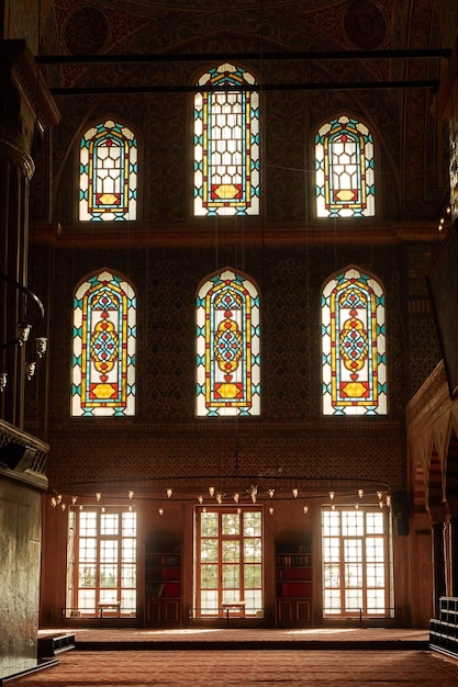 Stainedglass windows with colored ornaments columns and arches in the mosque of the city of Istanbul