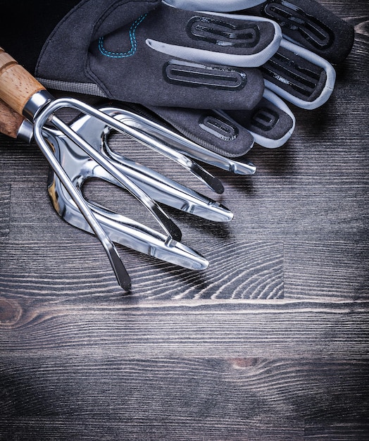 Stainless rake trowel fork safety gloves gardening concept.