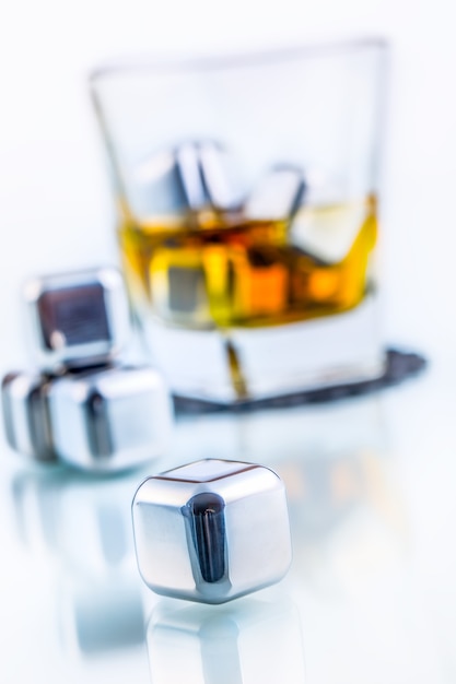 Stainless steel fake ice cubes with whiskey glass.