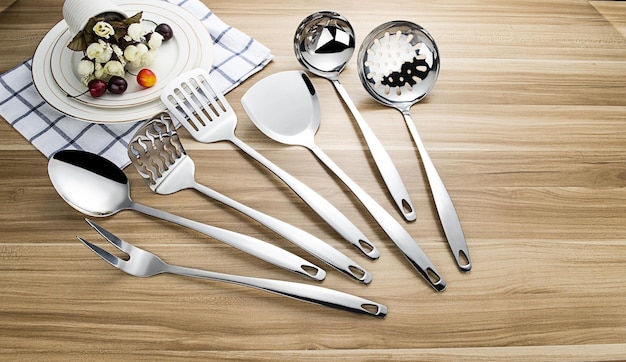 Stainless steel tableware and kitchen utensils placed on the desktop