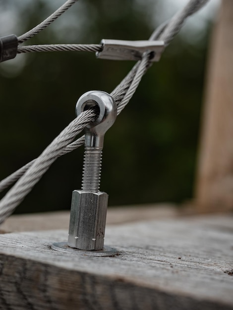 Photo stainless steel turn buckle and steel wire cable rope connection in detail view