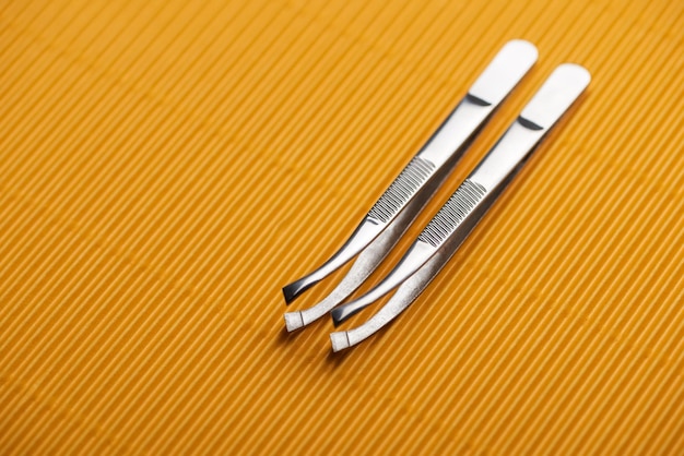 stainless steel tweezers yellow textured
