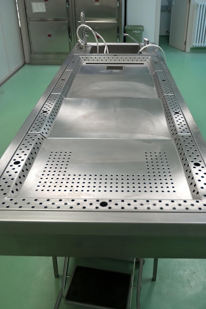 A stainless steel work table for post-mortem procedures and\
dissections