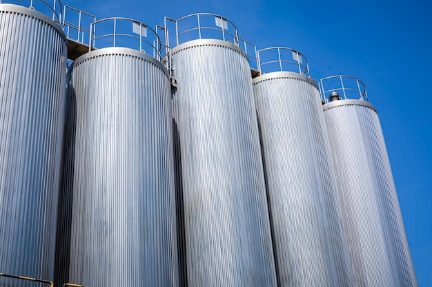 Stainless vertical steel tanks with equipment tank chemical cellar at the with stainless steel