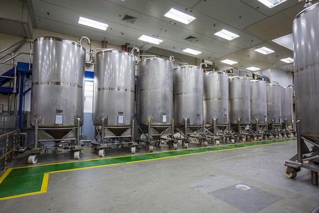 Stainless vertical steel tanks with pressure meter in equipment
tank chemical cellar at the with scrolling wheel stainless steel
tanks cleaning and treatment at shampoo plant