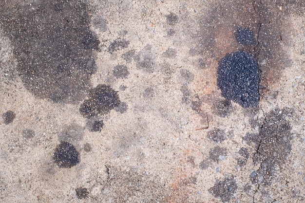 Stains of engine oil from cars that drip onto the floor in the parking lot car engine oil cement floor dirt old top view