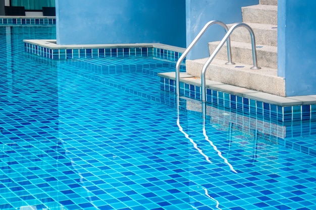 Stair of swimming pool with blue water