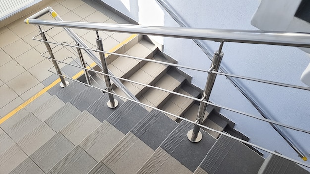 Staircase at the entrance of a multi-storey building. Steps of stairs in the staircase. Stairs inside the building.Stairwell in a modern building. Empty stairwell in a quiet building.