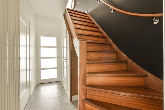 A staircase in a house with a black wall and