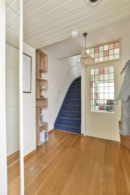 A staircase in a house with a blue stairwell