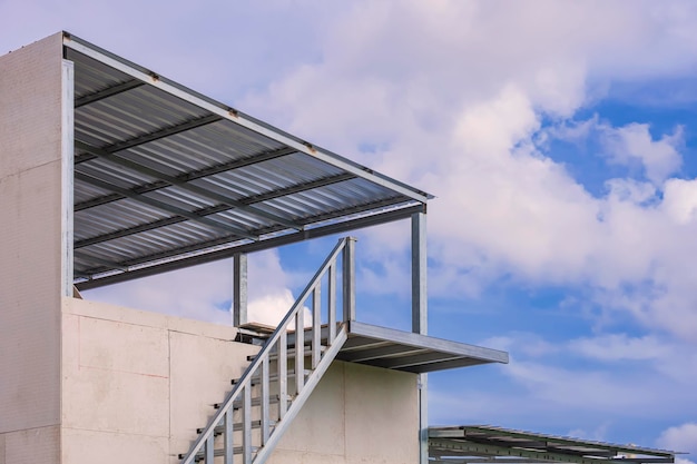 Staircase on smartboard wall with terrace structure of modern house against cloudy on blue sky