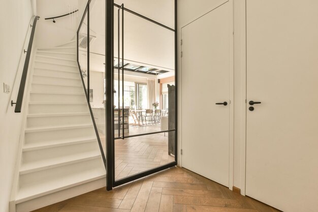 a staircase with a glass door leading to a hallway