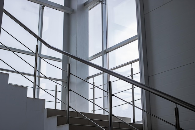 Staircase with metal railings by the window