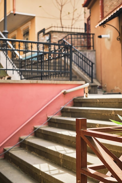 Stairs in the old city vertical frame selective focus on the railing idea for a postcard or background for advertising