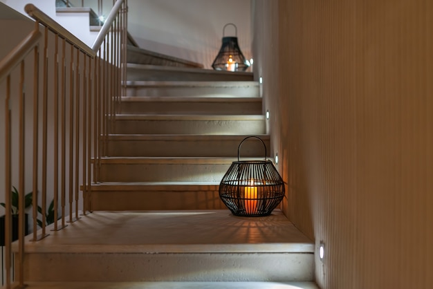 Stairs with illumination decorated with aunthetic lanterns.\
modern interior design. selective focus.