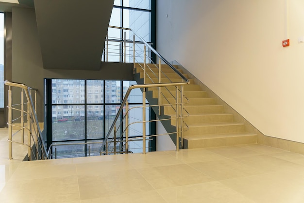 Stairwell in a modern building Staircases as an emergency evacuation exit from the building in case of fire or emergency Clean stairs and railings in the business center