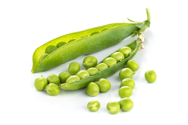 Stalk of green peas on a white surface