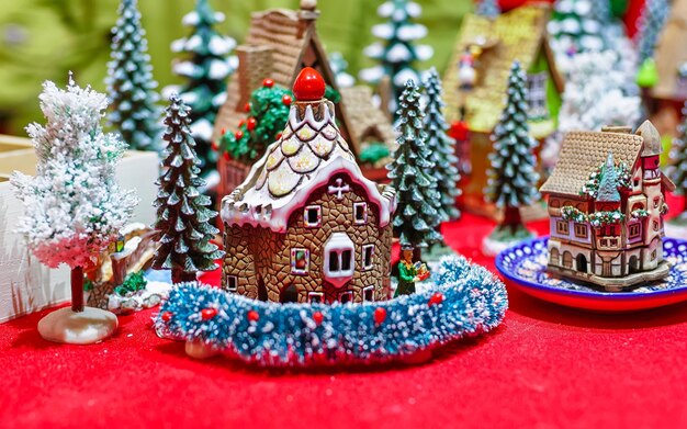 Stall with handmade ceramic houses and Vilnius Christmas Market, Lithuania. The fair at Cathedral Square in city. Street Xmas holiday fair. Advent Decoration and Stalls with Crafts Items on Bazaar