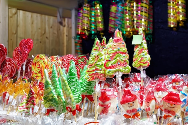 Stall with traditional colorful and festive candies at the Christmas Market in Vilnius, Lithuania. Candies are very popular at such markets. Selective focus