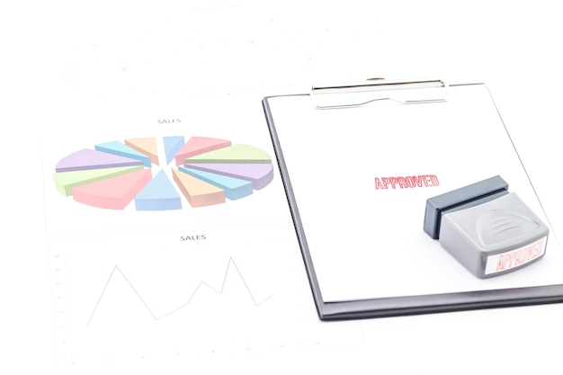 Stamp approved on clipboard and graph.