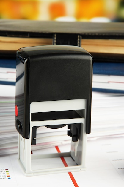 Stamp with notepads and papers on table
